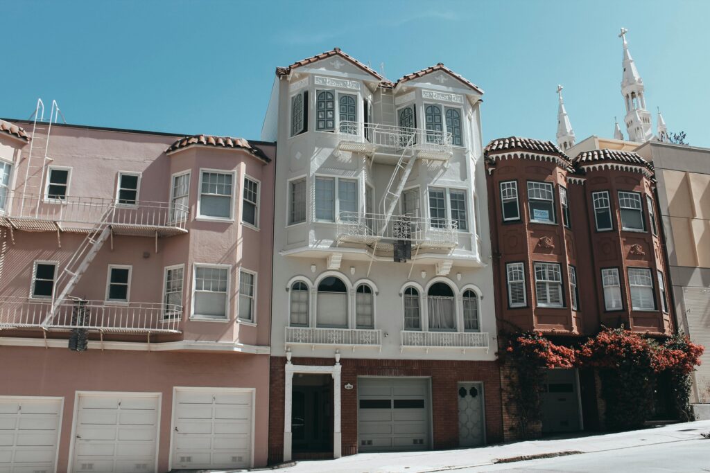 Charming Victorian buildings on a sunny San Francisco street.